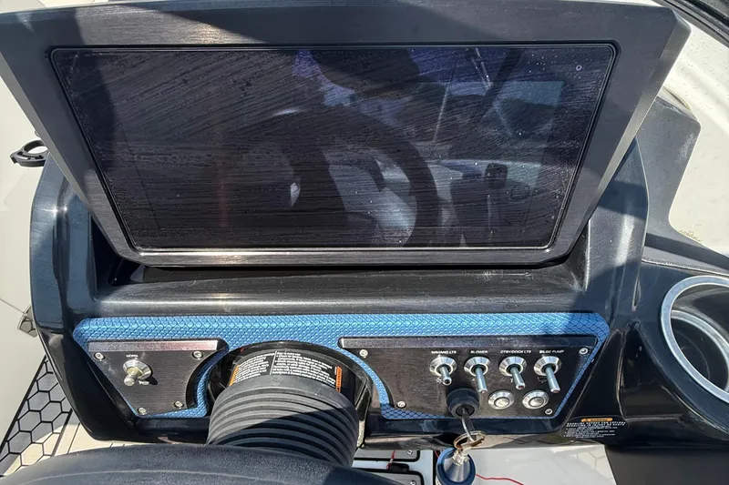 Slide: The Image of Dashboard of 2020 Scarab 255 Open ID boat with control panel and screen. - 13