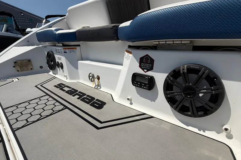 Slide: The Image of 2020 Scarab 255 Open ID boat interior with speakers and seating, showcasing modern design. - 17