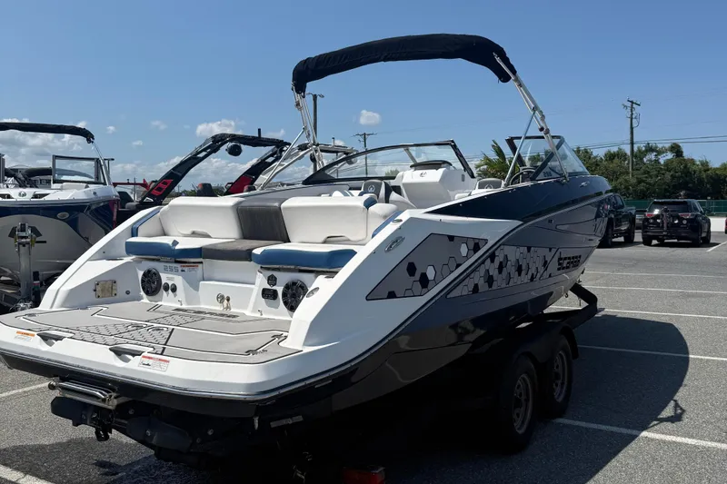 Slide: The Image of 2020 Scarab 255 Open ID boat in parking lot, showcasing sleek design and spacious seating. - 8