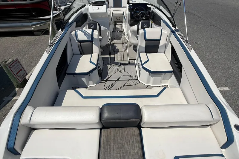 Slide: The Image of 2020 Scarab 255 Open ID boat interior with white and blue seating, modern design. - 11