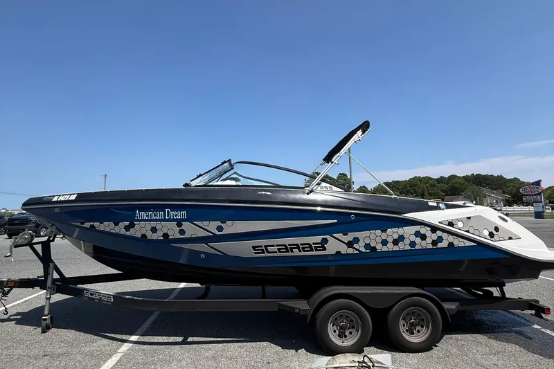 Slide: The Image of 2020 Scarab 255 Open ID boat on trailer, featuring sleek design and "American Dream" text. - 5