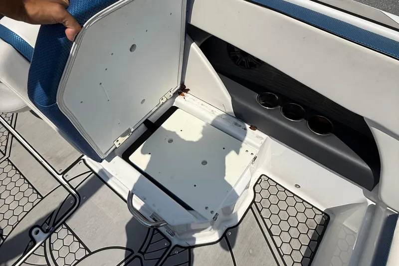 Slide: The Image of 2020 Scarab 255 Open ID boat seat storage compartment with cup holders and hexagonal floor design. - 15