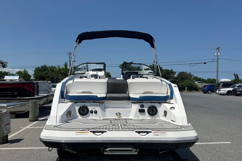 Slide: The Image of 2020 Scarab 255 Open ID boat in parking lot, rear view with seating and speakers. - 7