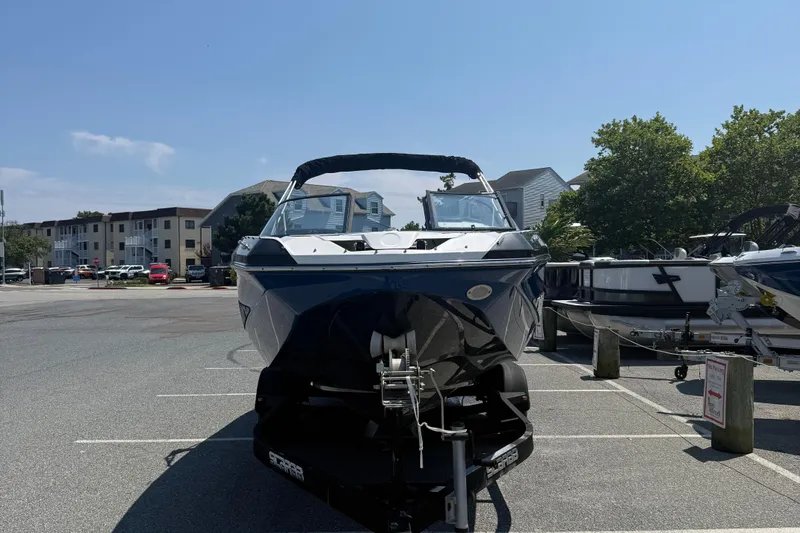 Slide: The Image of 2020 Scarab 255 Open ID boat on trailer in parking lot, sunny day. - 3