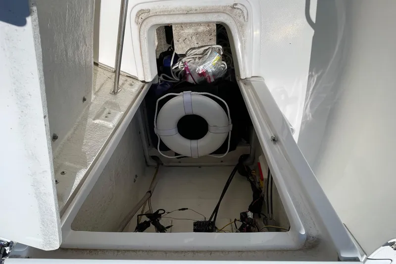 Slide: The Image of Storage compartment of a 2018 Robalo R180 Center Console boat, featuring a life preserver. - 9