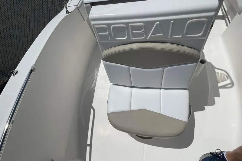 Slide: The Image of 2018 Robalo R180 Center Console boat seat with embossed branding. - 8