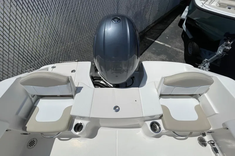 Slide: The Image of 2018 Robalo R180 Center Console boat with dual seats and outboard motor. - 6