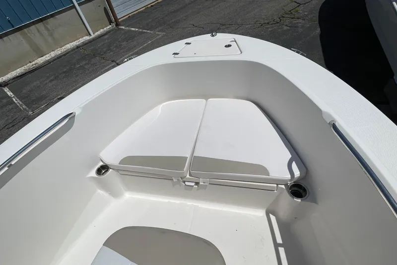 Slide: The Image of 2018 Robalo R180 Center Console boat interior with white seating and storage compartments. - 13