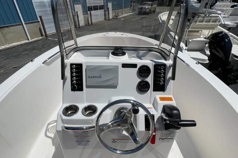 Slide: The Image of 2018 Robalo R180 Center Console boat dashboard with Garmin navigation system and steering wheel. - 3