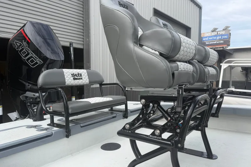 Slide: The Image of 2027 Skuta 24 Cat boat interior with gray seating and powerful Racing 400 engine. - 6