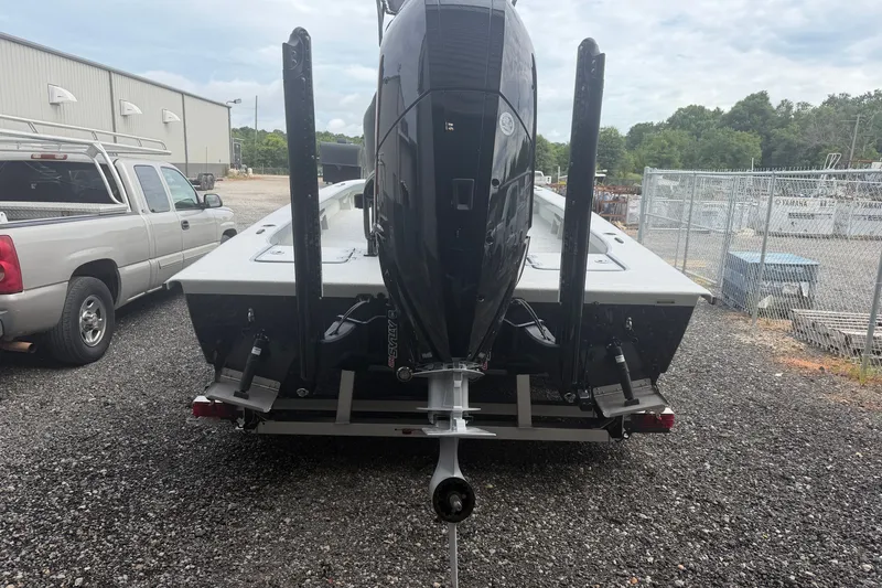 Slide: The Image of Rear view of a 2027 Skuta 24 Cat boat with an outboard motor. - 14