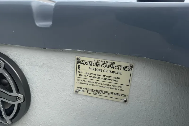 Slide: The Image of Plaque on Skuta 24 Cat 2027 boat showing maximum capacity and safety compliance. - 9