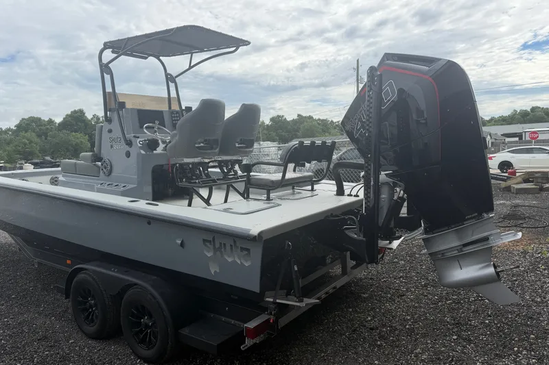 Slide: The Image of 2027 Skuta 24 Cat boat with dual seats and powerful outboard motor. - 19