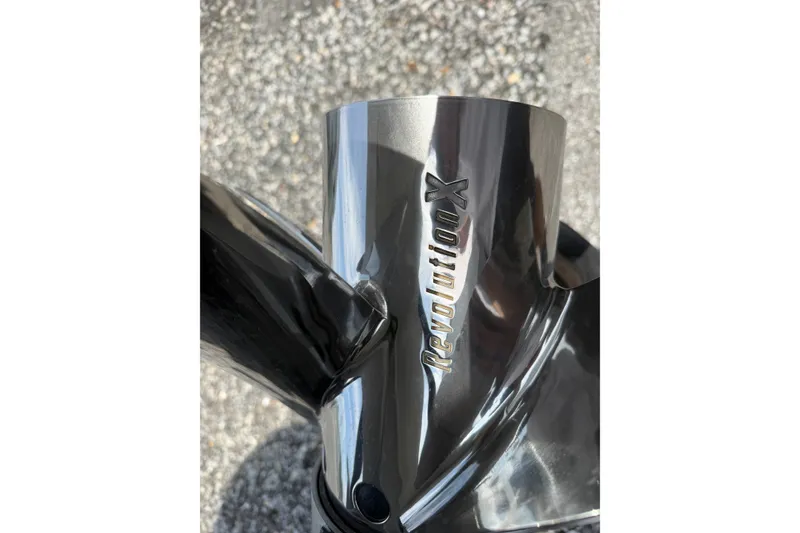 Slide: The Image of Close-up of Skuta 24 Cat 2027 propeller with "Revolution X" engraving. - 22