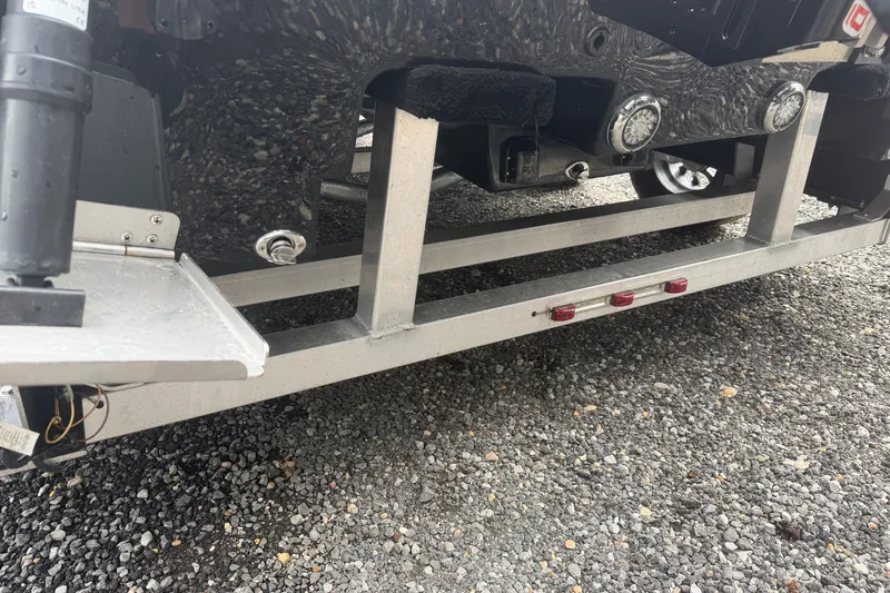 Slide: The Image of Close-up of Skuta 24 Cat 2027 boat trailer on gravel surface. - 16