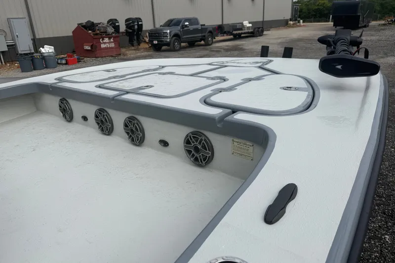 Slide: The Image of 2027 Skuta 24 Cat boat deck with speakers and storage compartments. - 10