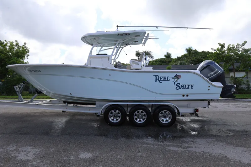 Slide: The Image of 2015 Sea Fox 286 Commander boat on trailer, labeled "Reel Salty," with Yamaha engine. - 6