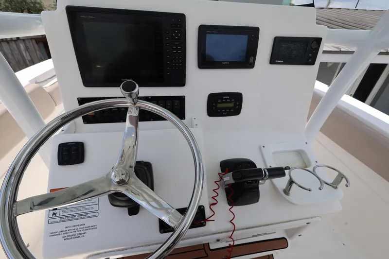 Slide: The Image of Control panel of a 2015 Sea Fox 286 Commander boat with steering wheel and navigation equipment. - 12