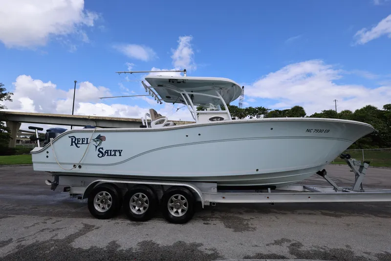 The Image of 2015 Sea Fox 286 Commander boat on trailer under blue sky. - 1