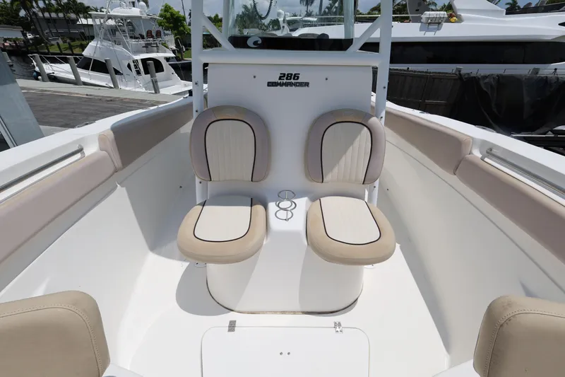 Slide: The Image of 2015 Sea Fox 286 Commander boat interior with cushioned seating and cup holders. - 18
