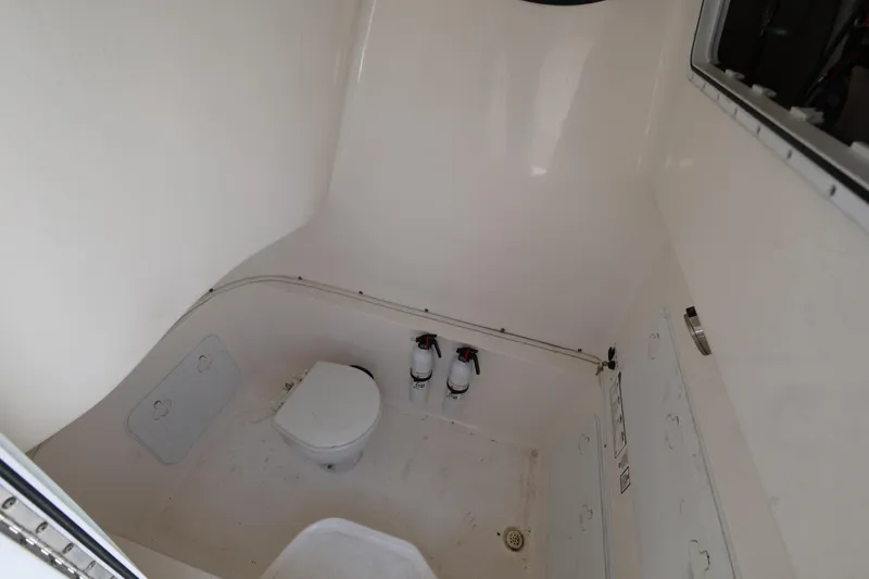 Slide: The Image of Interior of 2015 Sea Fox 286 Commander boat, featuring a compact marine toilet. - 20
