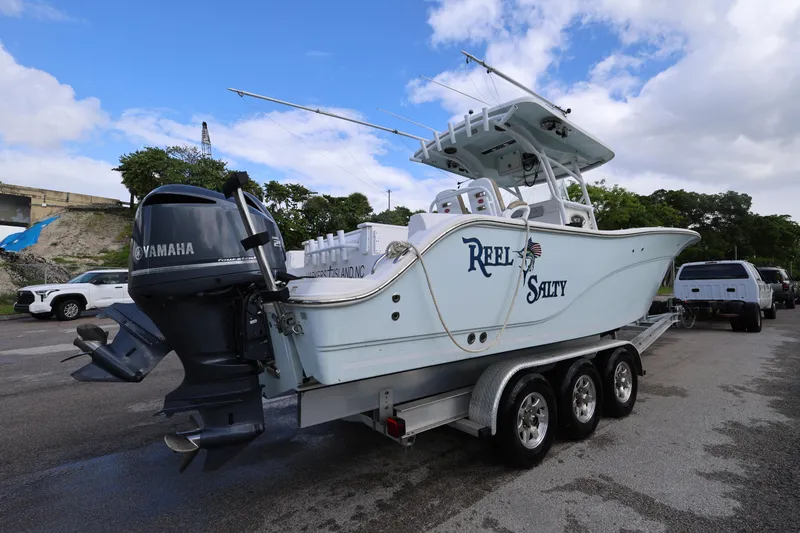 Slide: The Image of 2015 Sea Fox 286 Commander boat on trailer with Yamaha engines, parked outdoors. - 3
