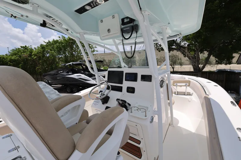 Slide: The Image of 2015 Sea Fox 286 Commander boat interior with helm, steering wheel, and seating. - 10