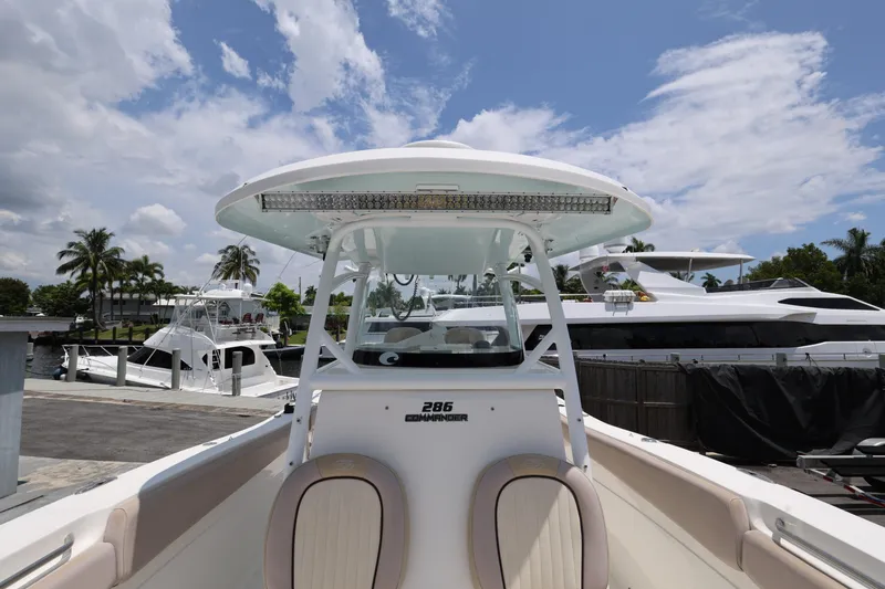 Slide: The Image of 2015 Sea Fox 286 Commander boat docked under a partly cloudy sky. - 19