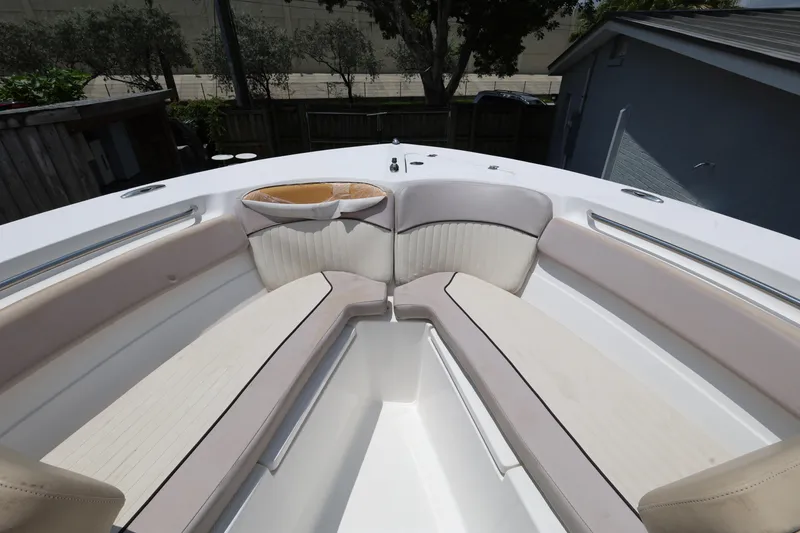 Slide: The Image of 2015 Sea Fox 286 Commander boat interior with cushioned seating and storage compartments. - 16