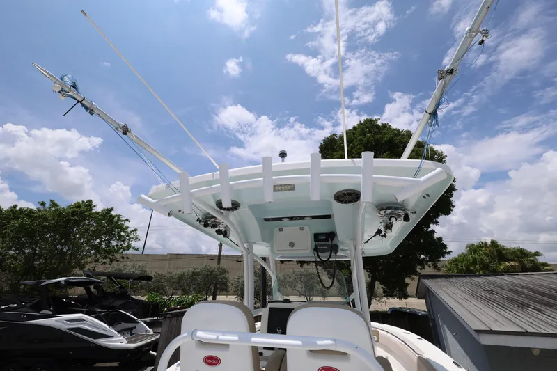 Slide: The Image of 2015 Sea Fox 286 Commander boat with fishing rod holders and electronics under a clear sky. - 9
