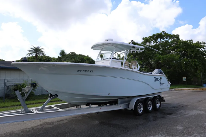 Slide: The Image of 2015 Sea Fox 286 Commander boat on trailer, parked outdoors under cloudy sky. - 4
