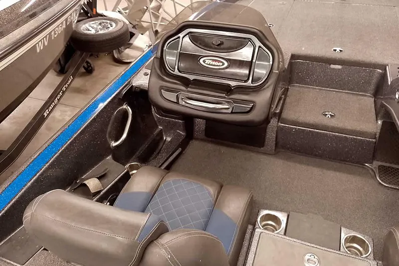 Slide: The Image of 2015 Triton 19 TrX boat interior with seating and dashboard details. - 25