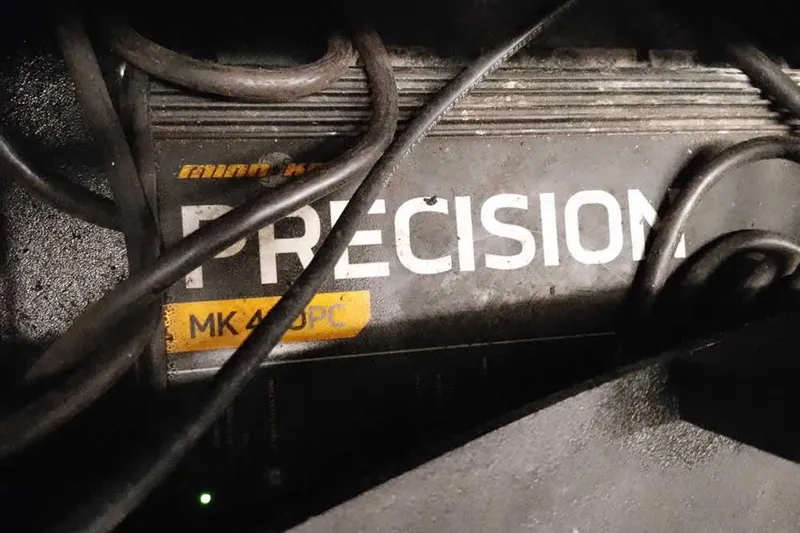 Slide: The Image of Precision MK 460PC charger in 2015 Triton 19 TrX boat, surrounded by cables. - 34