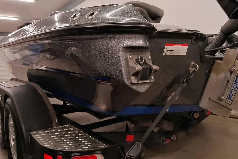 Slide: The Image of 2015 Triton 19 TrX boat on trailer, showcasing sleek design and metallic finish. - 15