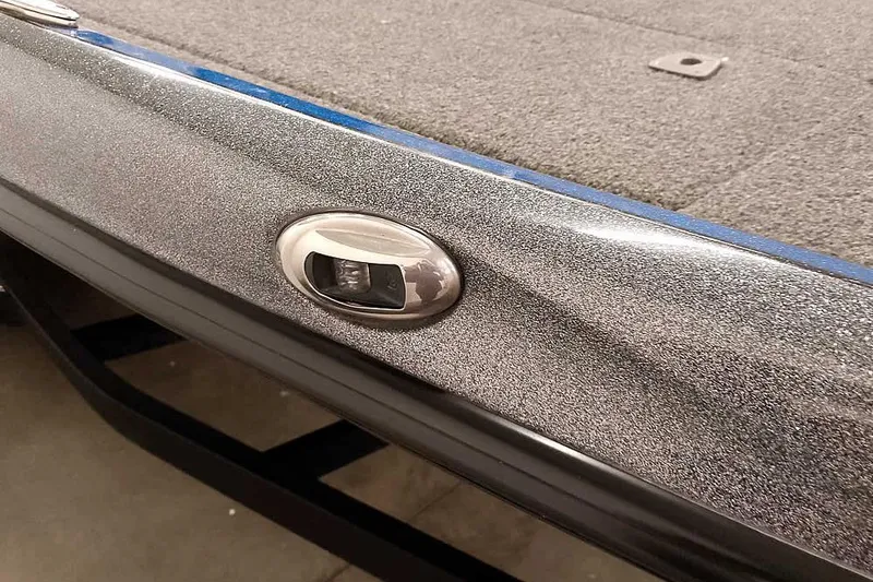 Slide: The Image of Close-up of a 2015 Triton 19 TrX boat's metallic finish and deck detail. - 36