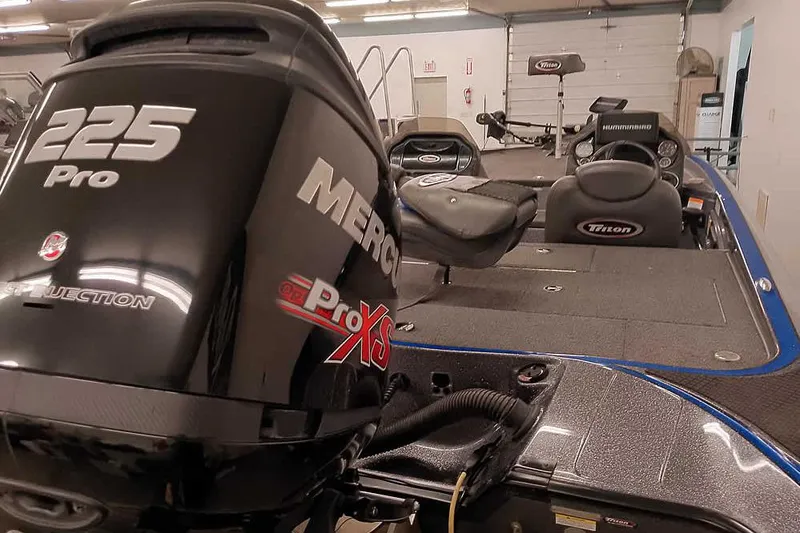 Slide: The Image of 2015 Triton 19 TrX boat with Mercury 225 Pro XS engine in a garage. - 3