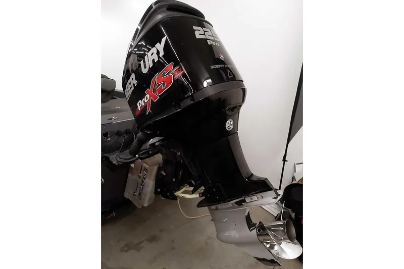 Slide: The Image of 2015 Triton 19 TrX boat with Mercury Pro XS outboard motor in garage. - 4