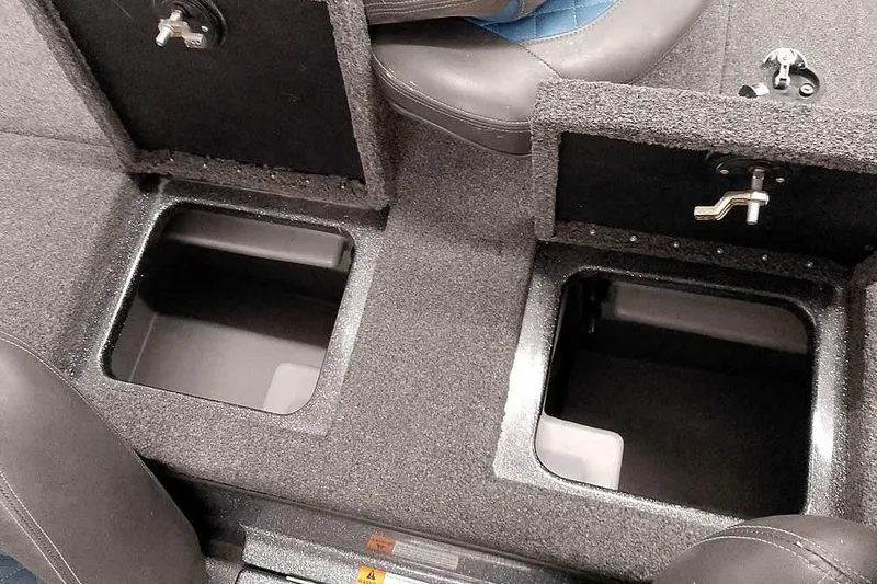 Slide: The Image of 2015 Triton 19 TrX boat storage compartments with open lids, showcasing interior space. - 31