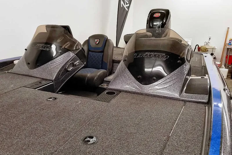 Slide: The Image of 2015 Triton 19 TrX bass boat interior with dual consoles and seating. - 13