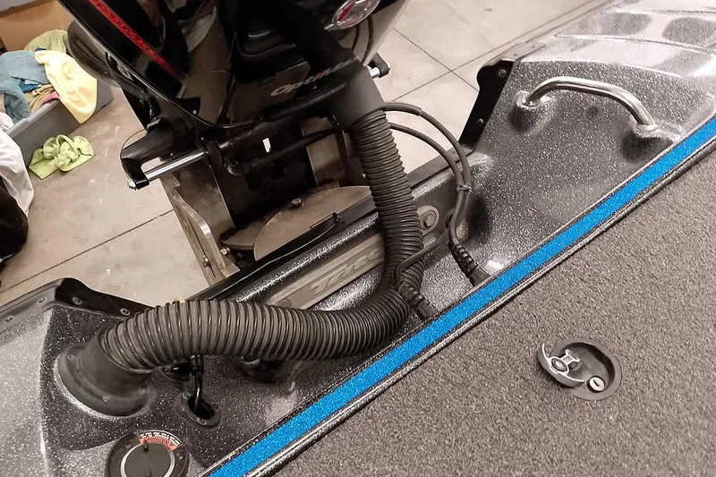 Slide: The Image of 2015 Triton 19 TrX boat engine compartment with cables and handle. - 33