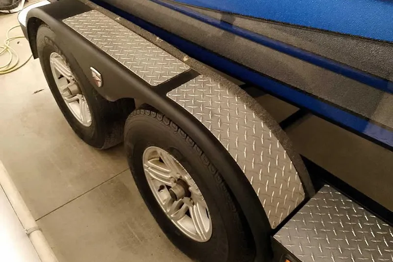 Slide: The Image of 2015 Triton 19 TrX trailer with dual wheels and diamond plate fenders. - 35