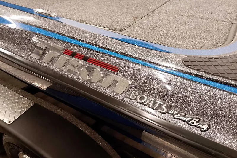 Slide: The Image of 2015 Triton 19 TrX boat detail with metallic finish and branding. - 7