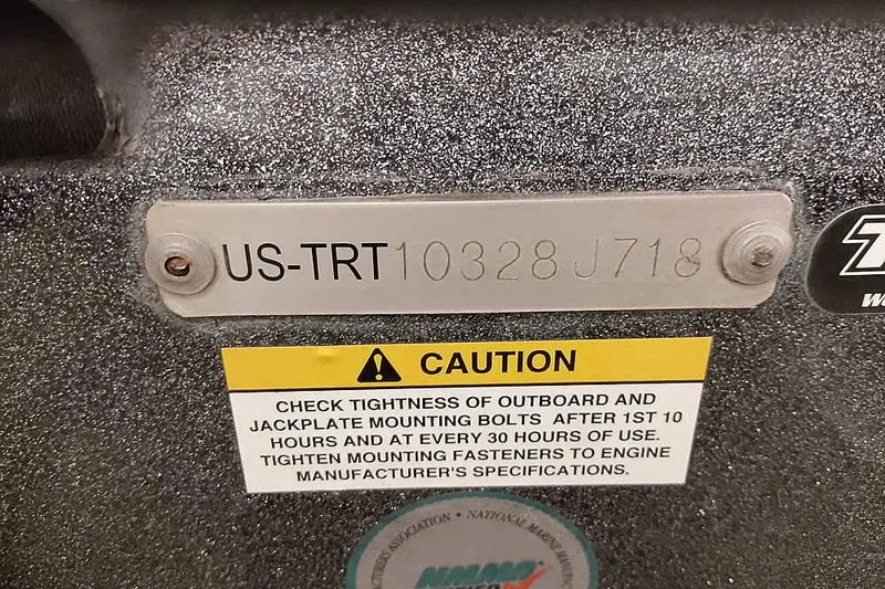 Slide: The Image of 2015 Triton 19 TrX boat identification plate with caution label for bolt tightness. - 2
