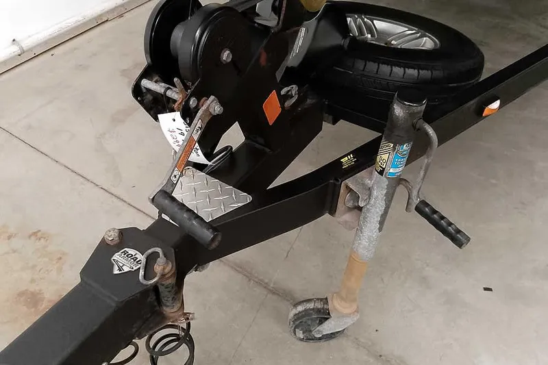 Slide: The Image of Trailer hitch and wheel assembly of a 2015 Triton 19 TrX boat trailer. - 10