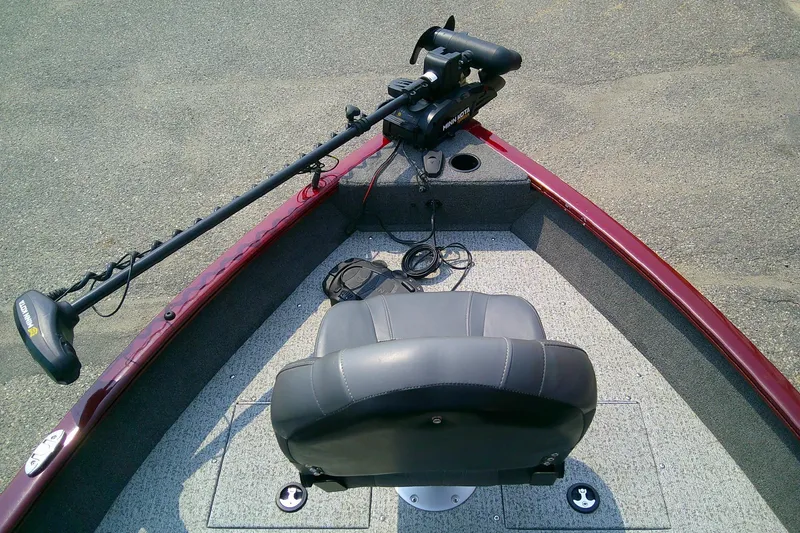 Slide: The Image of 2024 Tracker Pro Guide V-16 SC boat interior with trolling motor and seating. - 7