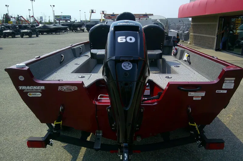 Slide: The Image of 2024 Tracker Pro Guide V-16 SC boat with Mercury 60 engine, displayed outdoors. - 4