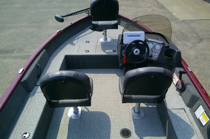 Slide: The Image of 2024 Tracker Pro Guide V-16 SC boat interior with steering console and seating. - 5
