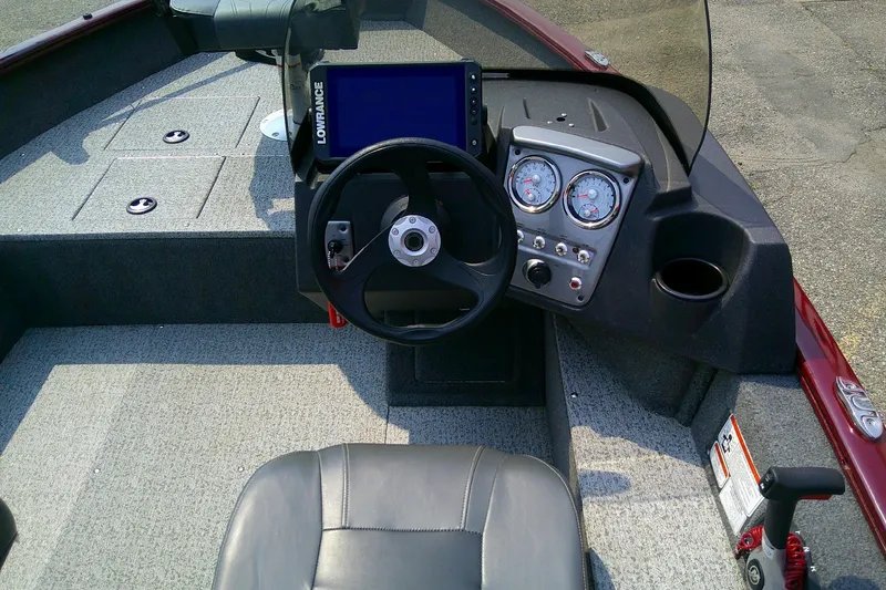Slide: The Image of 2024 Tracker Pro Guide V-16 SC boat dashboard with steering wheel and gauges. - 10
