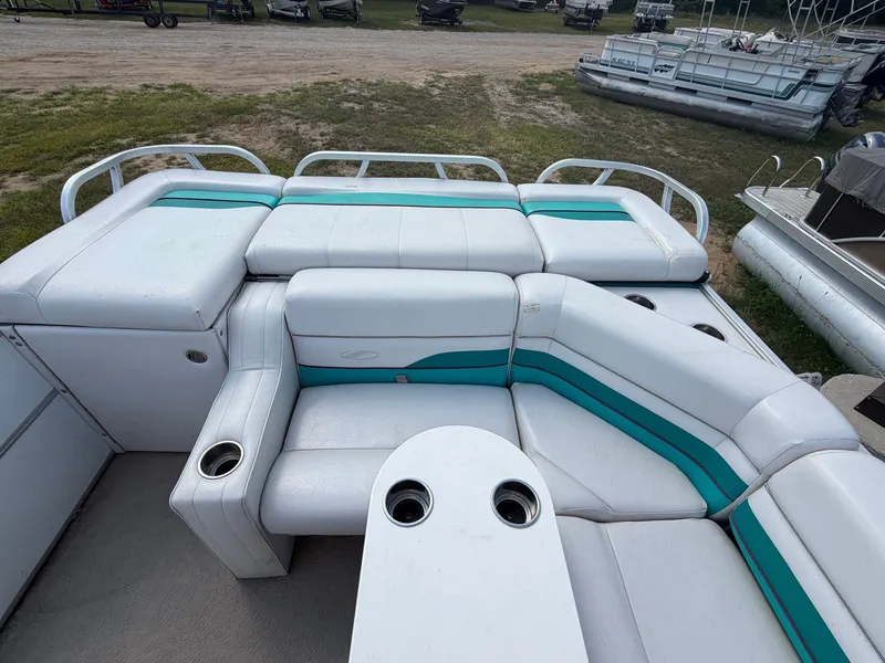 Slide: The Image of A 1994 Starcraft 240 Stardeck Pontoon with white and teal seating and cup holders. - 5