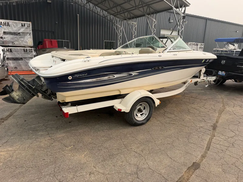 Slide: The Image of A 2005 Sea Ray 185 Sport boat on a trailer, parked on a concrete surface. - 6